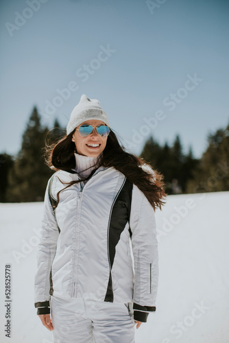 Young woman standing on the ski track