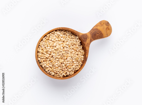 Bio natural sesame seeds on wooden bowl.