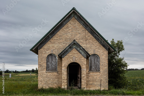 Small brick church abandoned on side of rural rode on overcast day © Richard