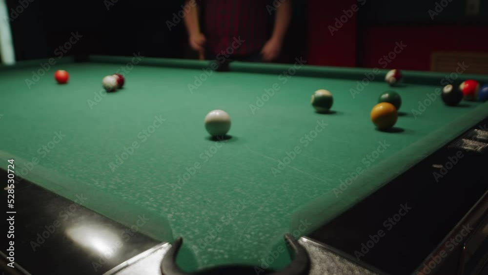 Overweight caucasian pool player enjoying sports game of billiard