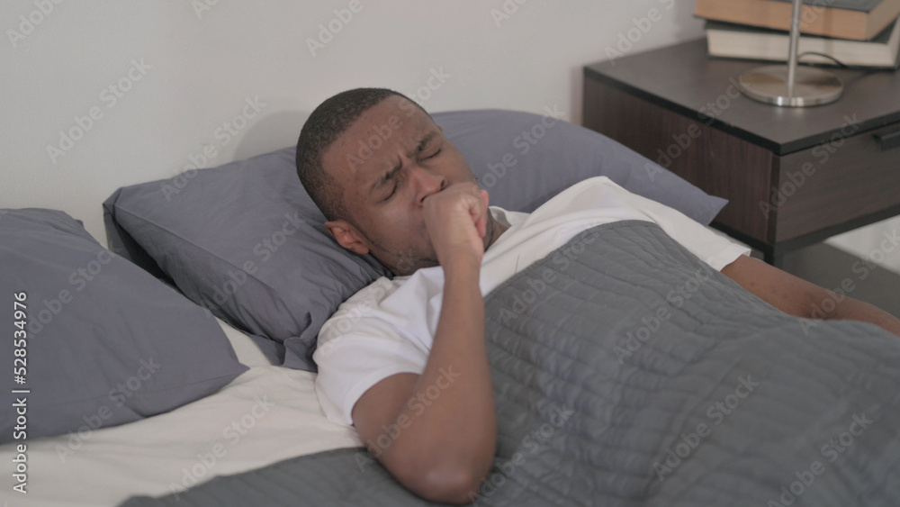 African Man Coughing while Sleeping in Bed African Man Coughing while Sleeping in Bed