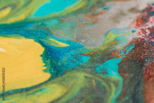 Mixing colors. Fluid magic. Creative painting. Blue yellow stream of liquid paint floating. Marble effect