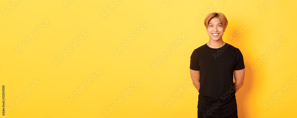Portrait of friendly handsome asian guy with blond hair, smiling ...