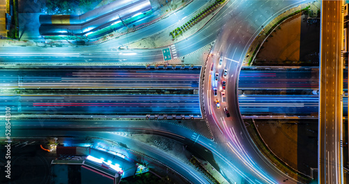 Car traffic transportation above intersection road in city night , Expressway top view, Road traffic an important infrastructure , aerial view cityscape of advanced innovation, financial technology