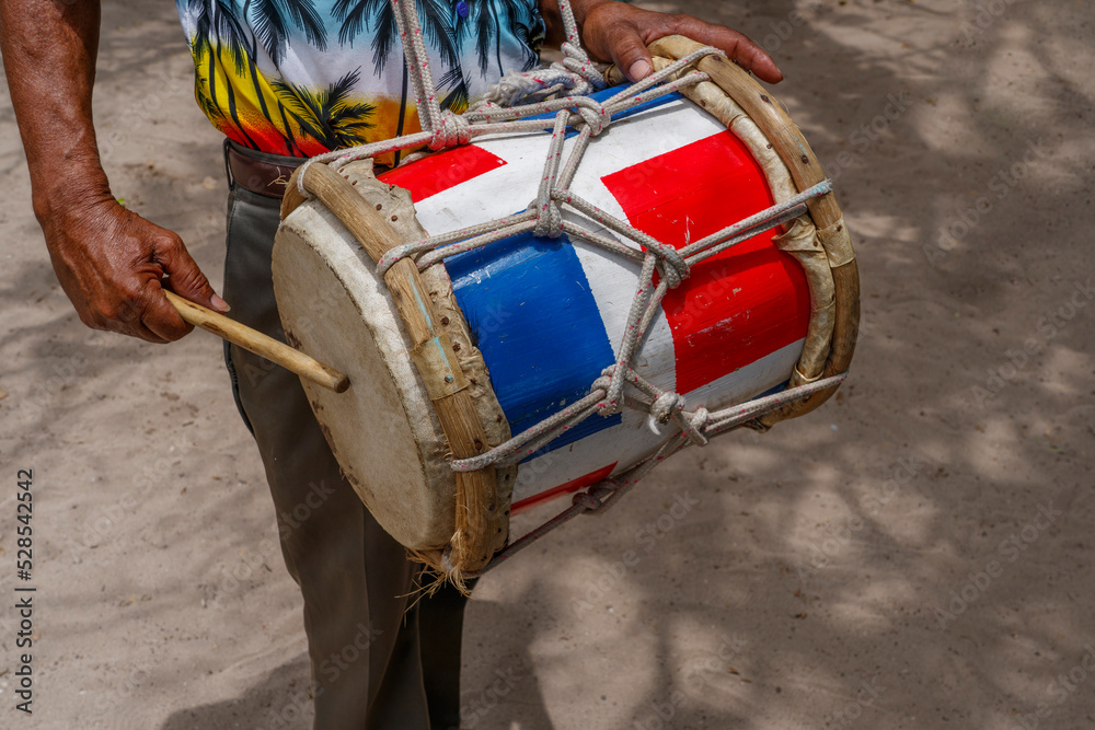 Dominican Republic. The beach musician plays the drum. Drummer. Closeup of the hand and drum