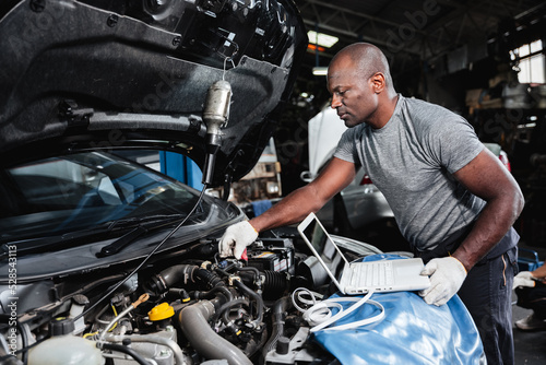 At the auto repair shop, the mechanics work on repairing and maintaining automobile engines to address any issues that may arise. © NewSaetiew