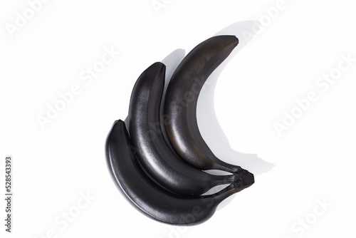 Black bananas on white background