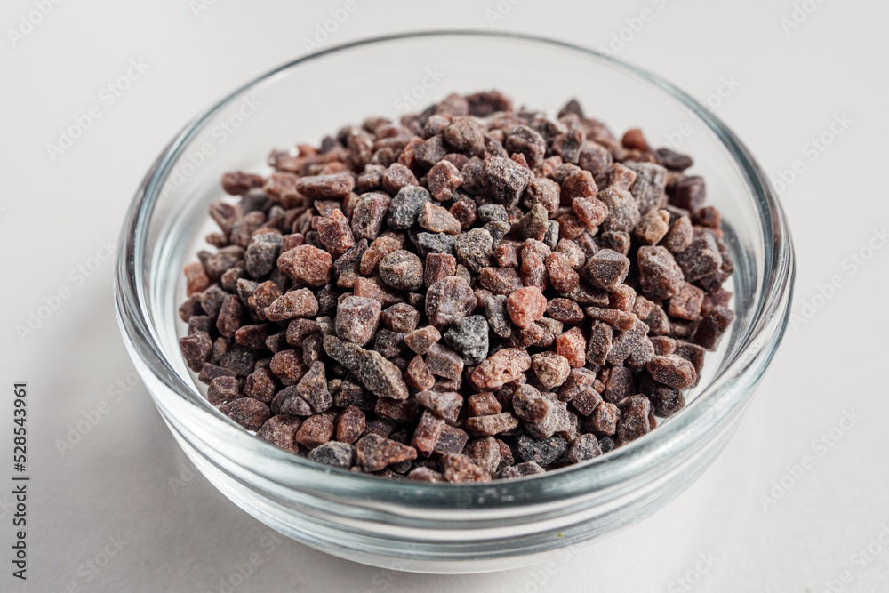 Black salt in glass bowl isolated in white background Black salt in glass bowl isolated in white background