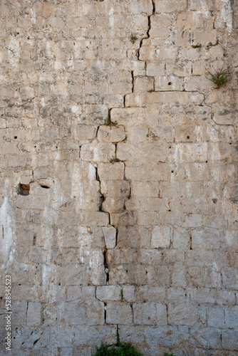 Old damaged stone wall background. 