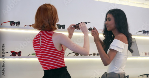 Bild auf Leinwand Candid young multiracial women shopping for sunglasses