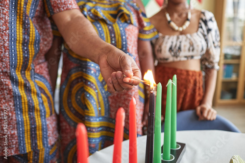 Close-up of African family burning seven candles for Kwanzaa holiday to celebrate it at home