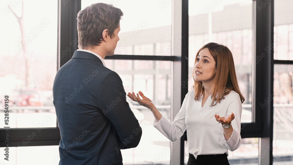 emotional woman gesturing during job interview with businessman in office. emotional woman gesturing during job interview with businessman in office.