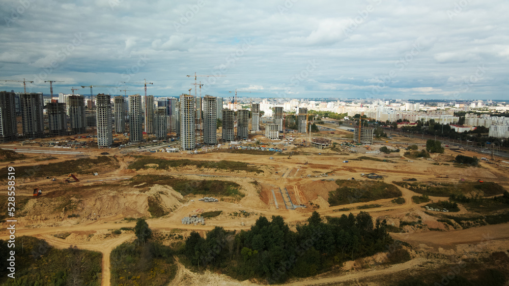 Fototapeta premium Construction site of a new city block. Construction of multi-storey buildings. Aerial photography.