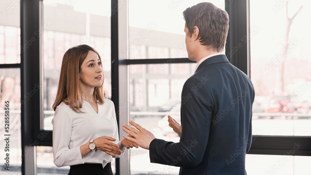 businessman and smiling woman gesturing during conversation on job interview. businessman and smiling woman gesturing during conversation on job interview.