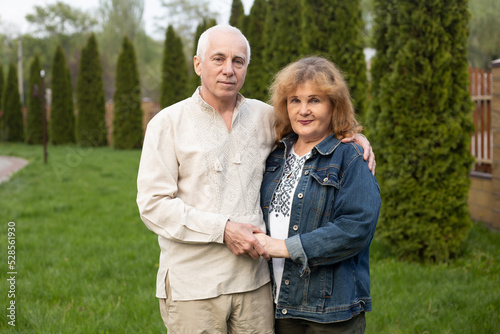Senior couple on a walk in summer nature, senior couple relax in spring summer time. Healthcare lifestyle elderly retirement love couple together © Marharyta