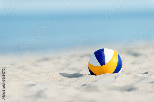 Beach volleyball ball on the sand beach. Horizontal sport theme poster, greeting cards, headers, website and app
