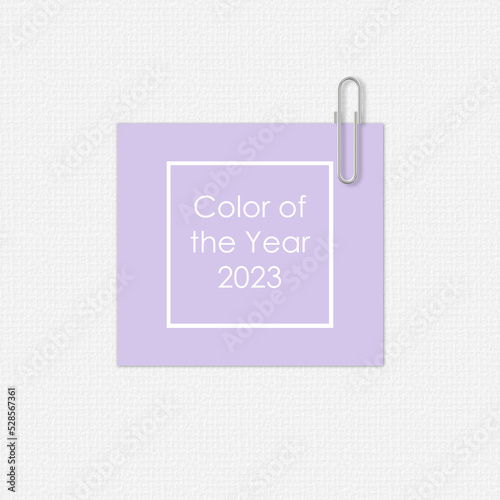 Lavender paper with a paper clip on white background. Digital Lavender Color of the Year 2023. Text Color of the year 2023 in frame