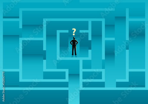 Businessman standing in the middle of the maze confusedly looking for a way out