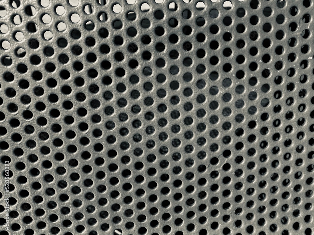 curved perforated metal sheet close up Black and white curved perforated metal sheet close up Black and white