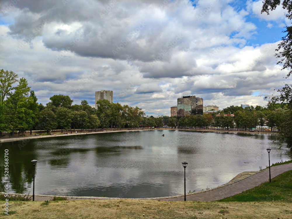 Autumn clouds over the Beketovsky Pond in Moscow