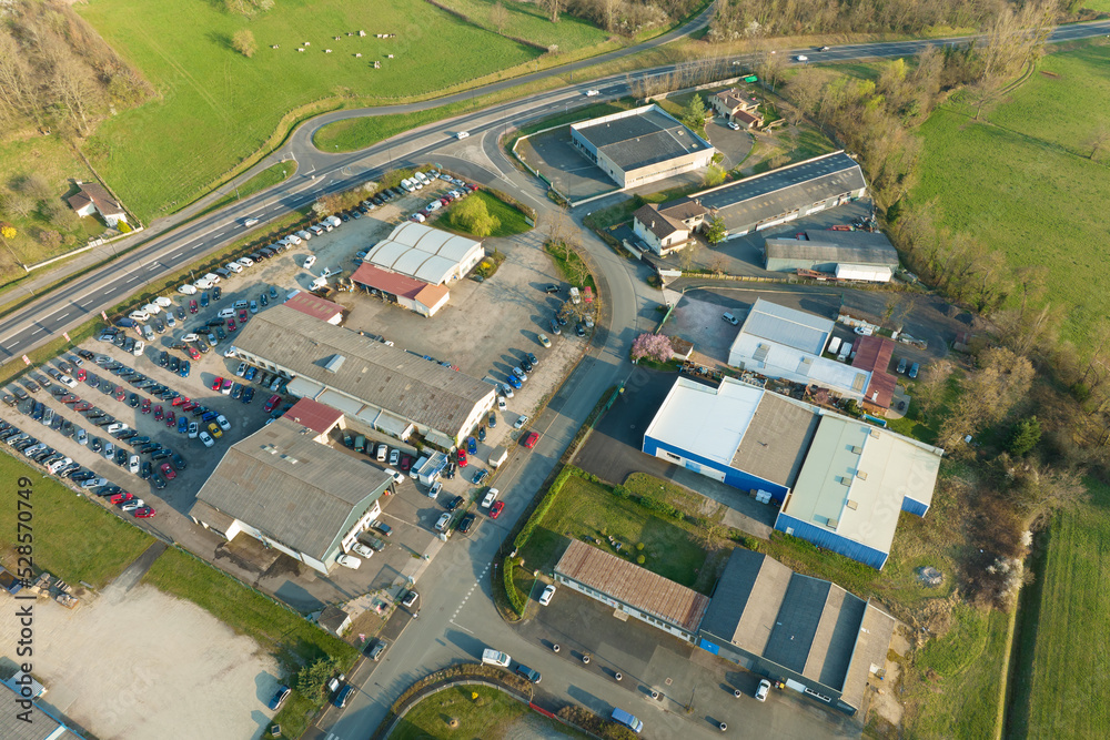© bilanol - Aerial view of goods warehouses and logistics center in industrial city zone from above © bilanol - Aerial view of goods warehouses and logistics center in industrial city zone from above