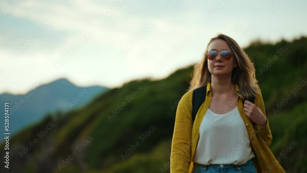 Woman tourist with backpack walking in mountains.
