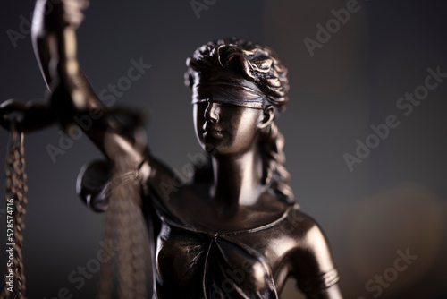 Law symbols composition. Law and justice concept. Themis sculpture and judge’s gavel on gray background.