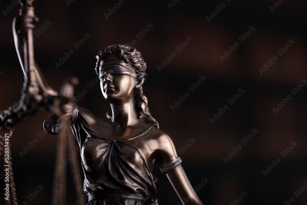 Law symbols composition. Law and justice concept.  Themis sculpture and judge’s gavel on gray background.