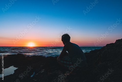 Sitting on a rock at sunset