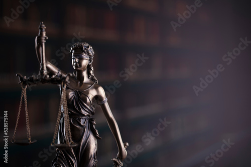 Law symbols composition. Law and justice concept. Themis sculpture and judge’s gavel on gray background.