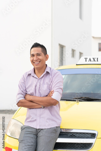 Photography Hispanic ethnic taxi driver posing with his work vehicle