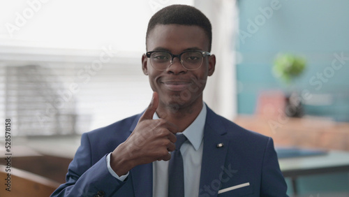 Young African Businessman showing Thumbs Up Sign