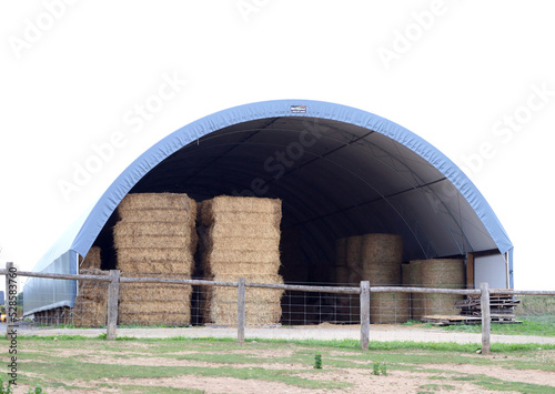 Barn storage shelter filled with bales of hay and straw