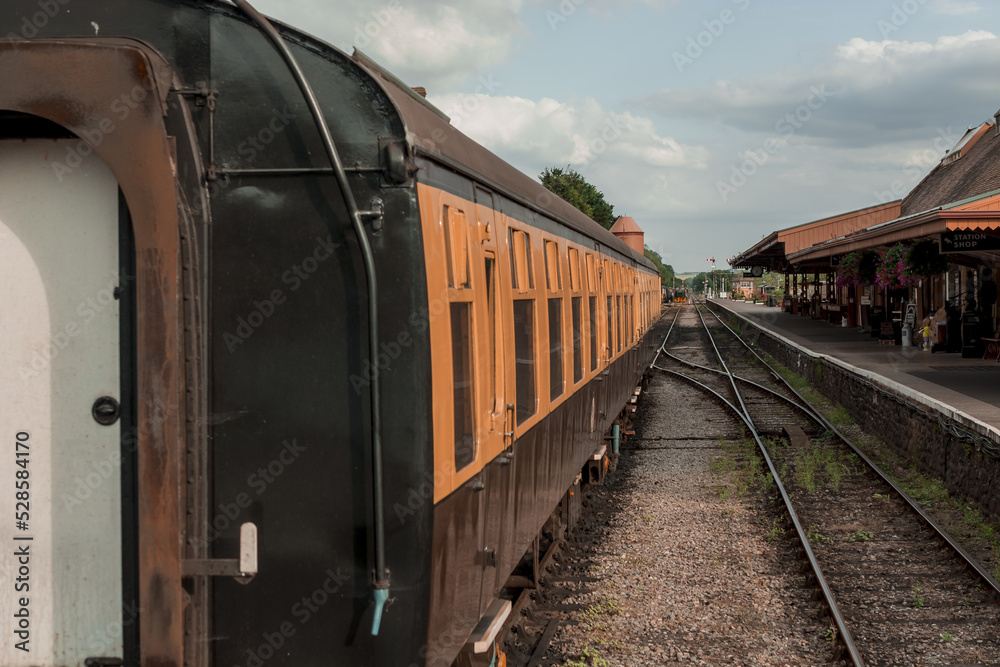 Restored Victorian-Era Passenger Rail train at a train station.