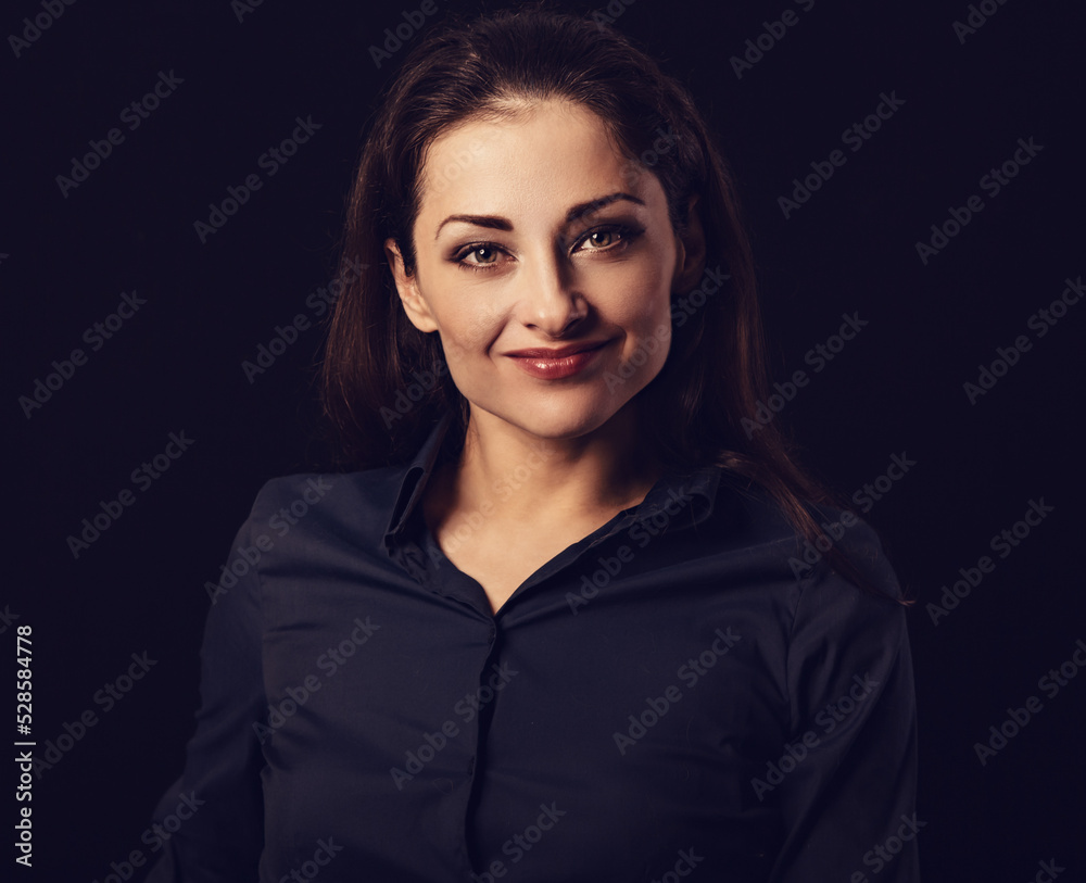 Beautiful thinking toothy laughing business woman with folded arms in blue shirt on black background with empty copy space. Closeup Beautiful thinking toothy laughing business woman with folded arms in blue shirt on black background with empty copy space. Closeup