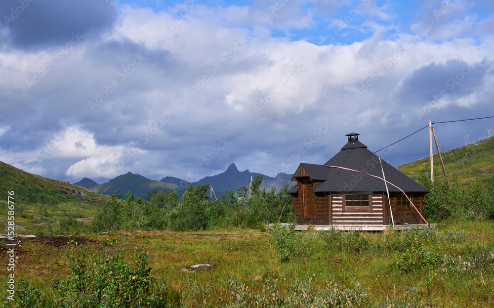 Wooden refuge in campground Storvatnet recreation area, Senja island. Summer vacation and hiking in Senja and Lofoten, northern Norway. Heavy clouds.