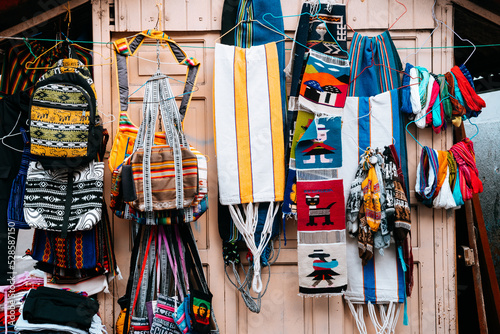 colorful scarfs pile at ecuadorian handcraft market photo