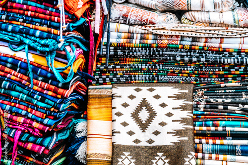 colorful scarfs pile at ecuadorian handcraft market