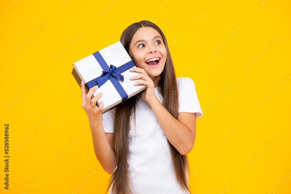 Emotional teenager child hold gift on birthday. Funny kid girl holding gift boxes celebrating happy New Year or Christmas. Excited teenager, glad amazed and overjoyed emotions. Emotional teenager child hold gift on birthday. Funny kid girl holding gift boxes celebrating happy New Year or Christmas. Excited teenager, glad amazed and overjoyed emotions.