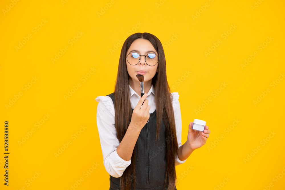 Beautiful portrait of teen girl child artist apply powder with make up brush. Makeup products. Beauty, and cosmetics for teenagers. Beautiful portrait of teen girl child artist apply powder with make up brush. Makeup products. Beauty, and cosmetics for teenagers.