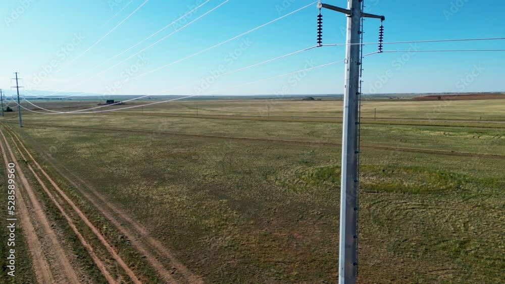 Transmission line for electric power grid delivering high voltage electricity through countryside rural southern wyoming from cinematic dji aerial drone 4k video for renewable green sustainable energy Transmission line for electric power grid delivering high voltage electricity through countryside rural southern wyoming from cinematic dji aerial drone 4k video for renewable green sustainable energy