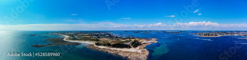 Aerial view of the Pointe de Kerpenhir at the entrance of the Gulf of Morbihan in Brittany, France - Panoramic view of the rocky peninsula at low tide