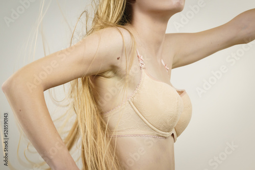 Woman wearing too big bra photo