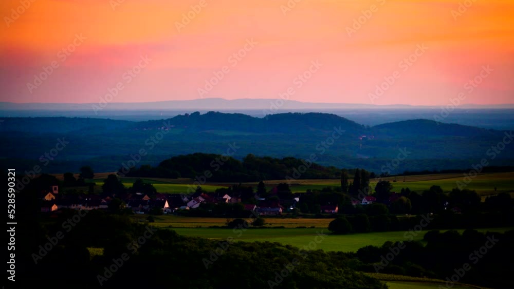 Timelapse of sunset over Buvilly village, Jura region, Bourgogne-Franche-Comte in eastern France. View from viewpoint Belvedere du vignoble. Timelapse of sunset over Buvilly village, Jura region, Bourgogne-Franche-Comte in eastern France. View from viewpoint Belvedere du vignoble.