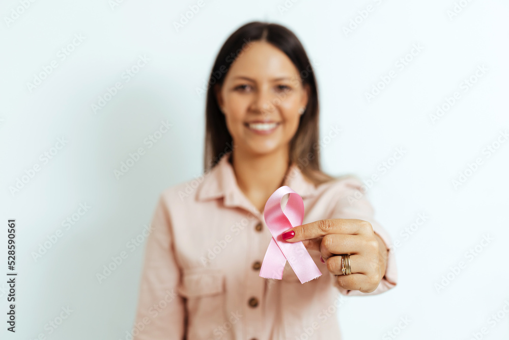 Woman holding pink ribbon, breast cancer awareness, pink october concept. Selective focus on pink ribbon Woman holding pink ribbon, breast cancer awareness, pink october concept. Selective focus on pink ribbon