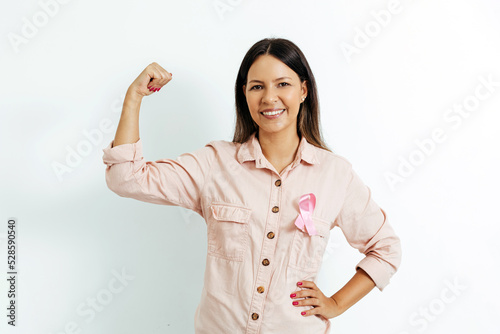 Young Brazilian woman with breast cancer ribbon over white background Fototapeta
