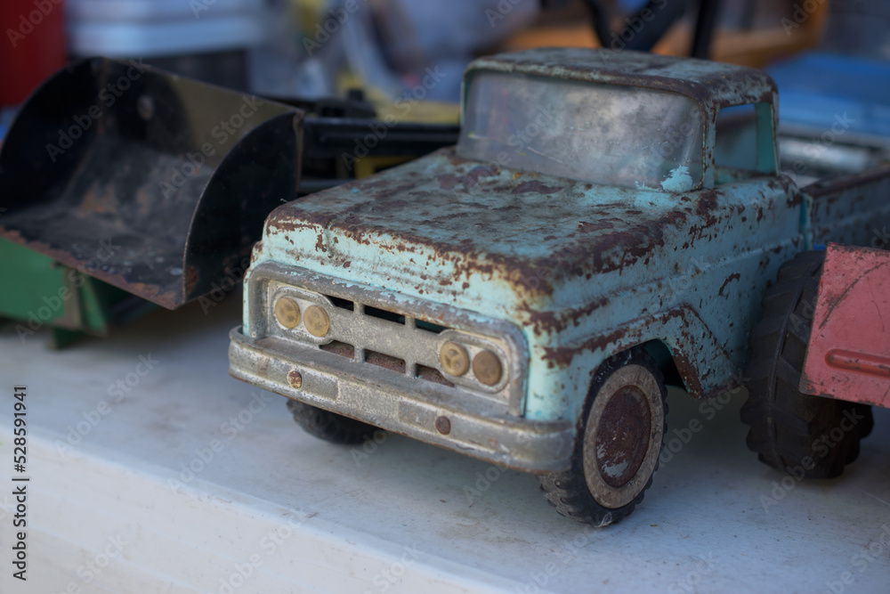 An old rusty truck is actually an antique for sale at this flea market in Upstate NY.  Well worn blue toy truck on display and for sale.