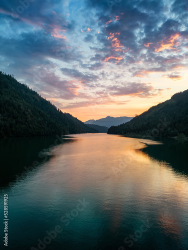 River and mountains in Canadian Nature during colorful Sunset. Harrison River, British Columbia, Canada. Vertical Background