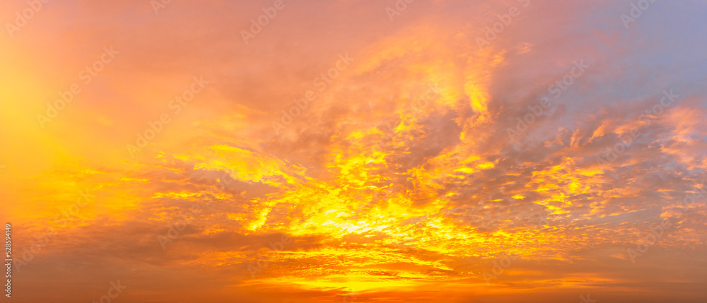 panorama background of the sky covered with clouds and morning sun during the golden hour