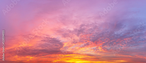 panorama background of sky covered with multicolored clouds from the morning sunlight © c_atta